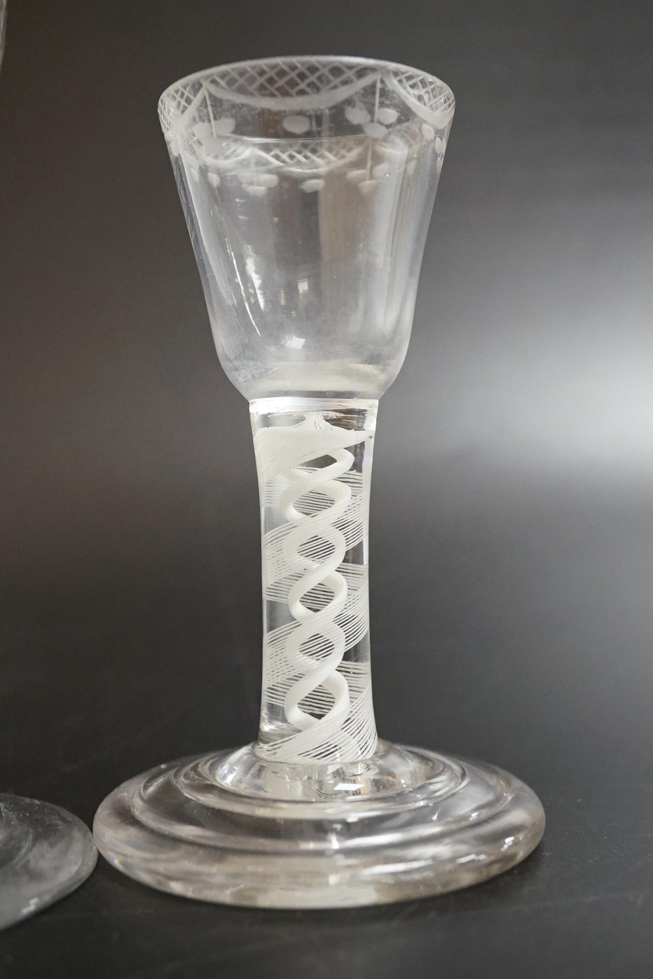 An opaque twist firing glass with terraced foot and a faceted wine glass with domed foot, c.1760, tallest 14cm